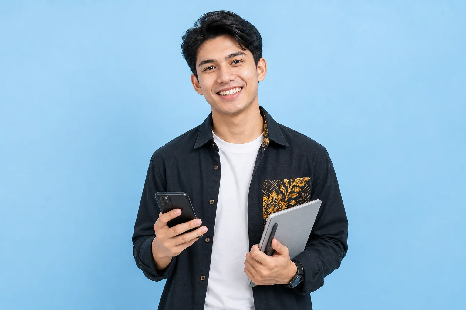 Malaysian content creator holding a phone and tablet on a blue background